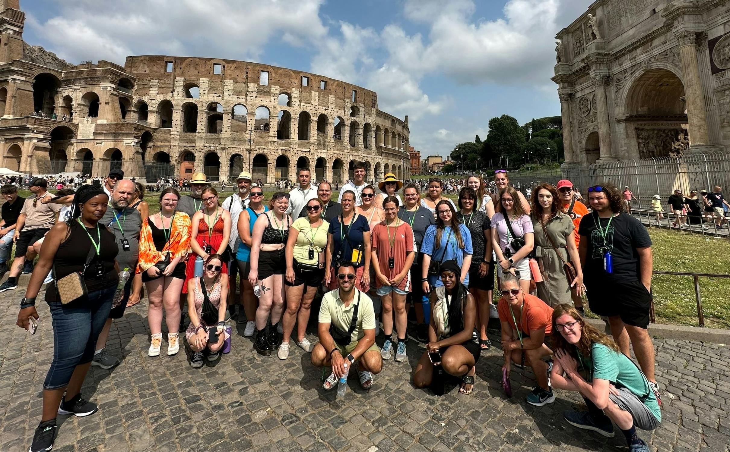 A group photo with the Colosseum in the background.